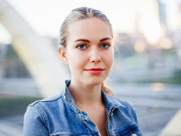 woman in blue top with blond hair