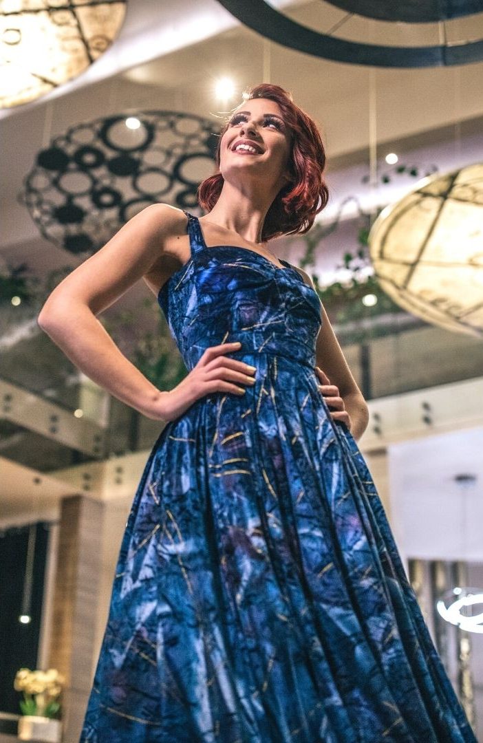 redhead in a blue dress