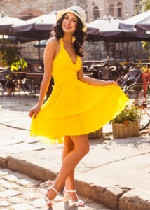 beautiful young brunette in a yellow dress