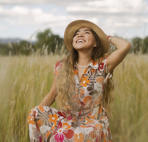 woman smiling wearing a dress