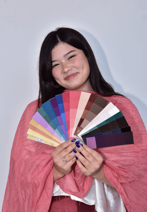A Client with a color palette and pink fabric