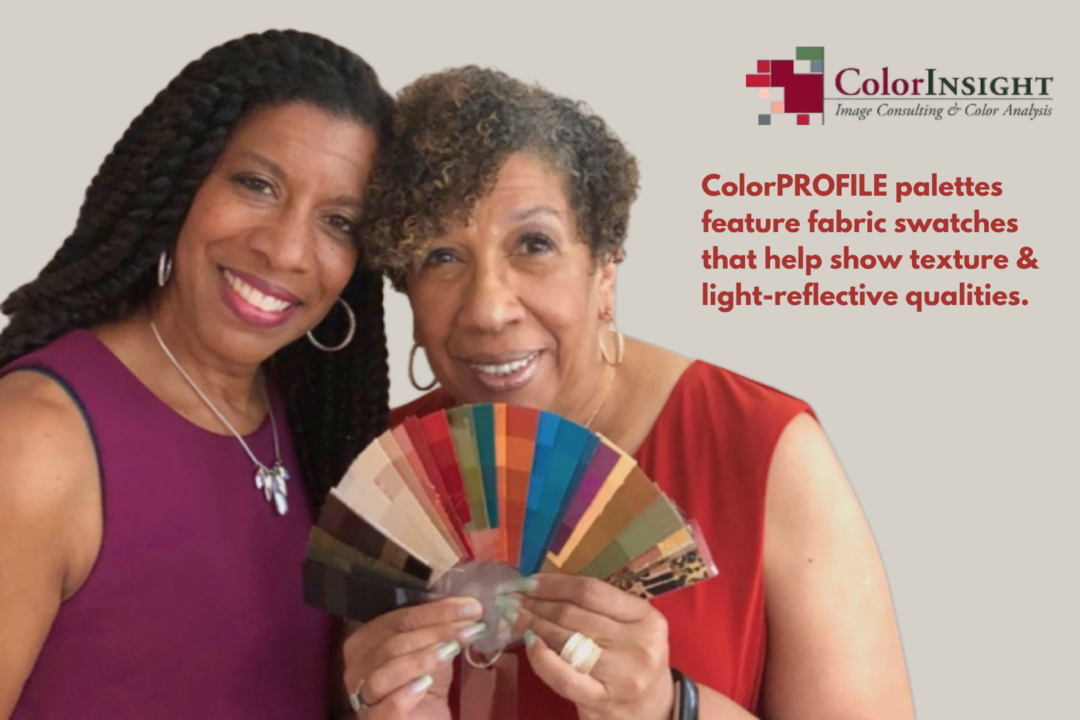 Two women holding a ColorPROFILE fabric swatch.